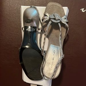 Dressy silver 2 1/2” heels with rhinestone center flower.